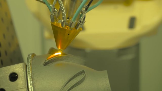 Metalworking, robotic, industrial concept. Direct metal deposition - advanced additive laser melting and powder spray manufacturing technology for repair, rebuild metal workpieces - close up