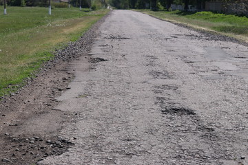 Highway with holes on Ukrainian roads, broken asphalt, Horizontal orientation