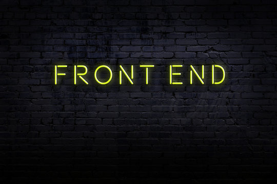Night view of neon sign on brick wall with inscription front end