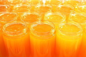 A bunch of flower honey in close-up lidless jars