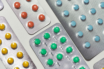 Composition with many medical pills, tablets pack in blister lying diagonally. Health care, vitamins and treatment concept