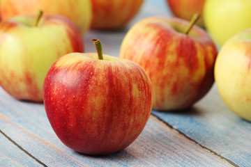 Several ripe red apples on the wooden table