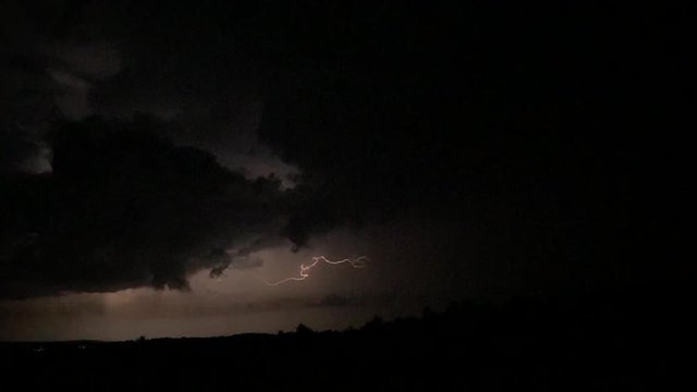 Slow motion of an electric storm far on the horizon