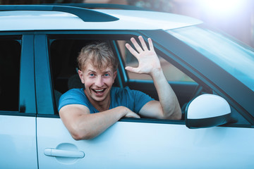Naklejka premium Attractive elegant happy man in good car. Fun. Happy day. Smile. Travel concept. Vacation. Car. 