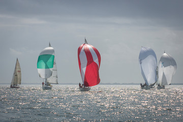 Sailing regatta in Galveston Bay Texas with sailboats using spinnakers on a downwind leg
