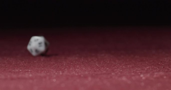 Close-up of White 20-Sided Dice Rolling in Slow Motion Revealing 6 Side