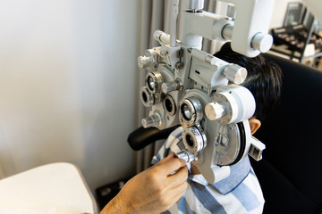 optometrists are examining pediatric patients' eyes with the Autorefractor