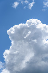 Cumulus cloud against a blue sky on a clear sunny day
