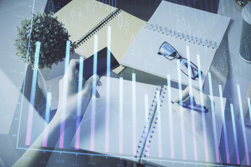 Multi exposure of woman on-line shopping holding a credit card and financial graph drawing. Stock market E-commerce concept.