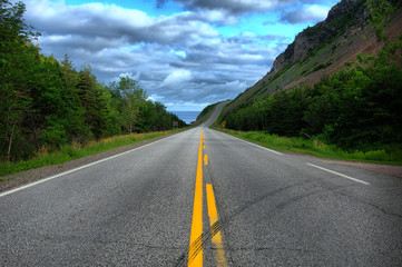 An HDR image of a straight scenic Road on the Cabot Trail in Nova Scotia, Canada.  