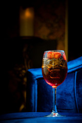 Wine glass with aperol spritz, italian alcoholic cocktail on dark background