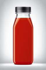 Plastic Bottle with tomatoes Juice on background. 