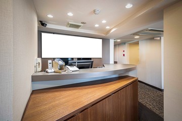 Blank advertising signs placed behind the reception counter at the office building.