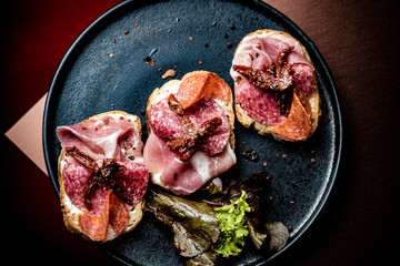 Tapas on Crusty Bread - Selection of Spanish tapas served on a sliced baguette.