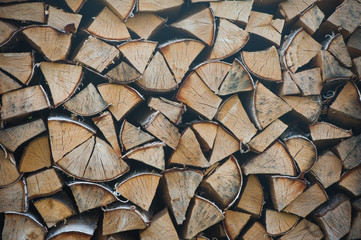 A neatly folded log made of chopped wood. Preparation of firewood for the winter. Rural life. Melting fire. background for text.