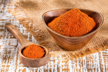 Paprika powder in a wooden bowl - Capsicum annuum