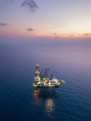 Aerial view offshore jack up rig at the offshore location during sunset