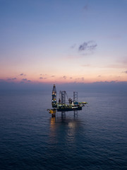 Fototapeta na wymiar Aerial view offshore jack up rig at the offshore location during sunset