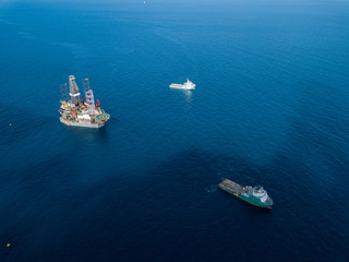 Offshore jack up rig and tow vessels during the rig move operation at the offshore location