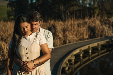Young couple embracing each other waiting for the baby. Natural environment Pregnancy concept