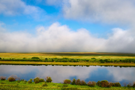 The river ,cloudscape and morning fog  in the grassland.