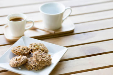 chocolate chip cookies with coffee on table.
