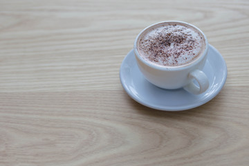 cup of cappuccino on table.