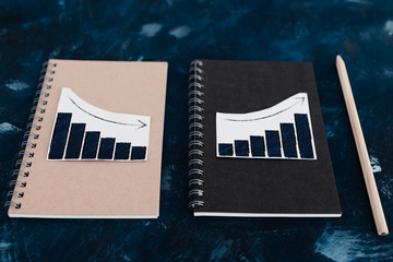 business analysis and statistics, desk with mixed graphs and charts on notebooks