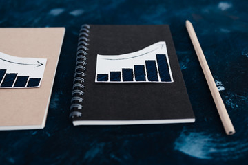 business analysis and statistics, desk with mixed graphs and charts on notebooks
