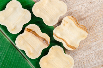 Cup from dried betel nut leaf palm, natural material.