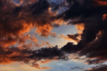 Fototapeta na wymiar Orange-black close-up sunset clouds
