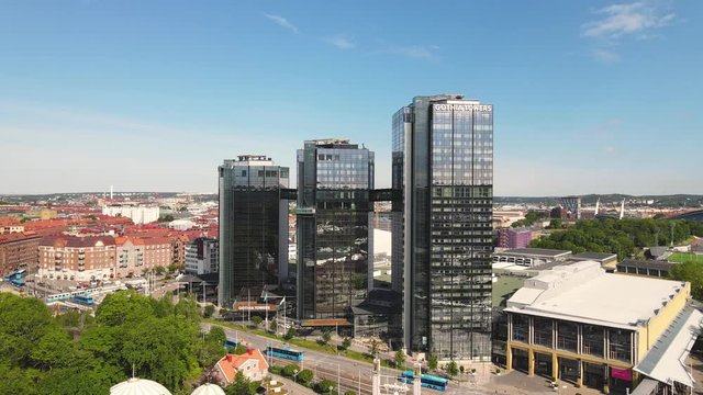Drone shot at glass fronted with reflections buildings next to Liseberg amusement, G&ouml;teborg. Aerial view of Gothia Towers. Gothenburg Sweden. Swedish skyline city view of modern towers for tourists.