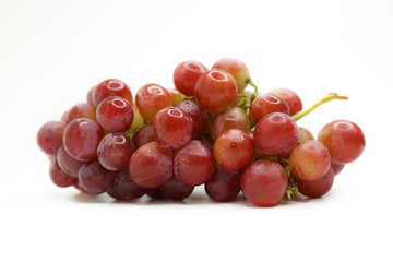 Close-Up Of Red Grapes Against White Background