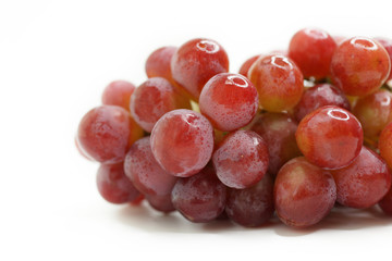 Close-Up Of Red Grapes Against White Background