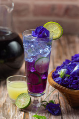 Healthy drink, organic blue pea flower tea with lemon and lime.