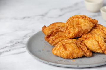 Stuffed chicken curry puffs on the table fall beautifully.