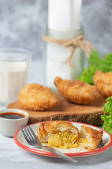 Stuffed chicken curry puffs on the table fall beautifully.