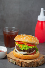 Hamburger with fried meat, tomatoes, pickles, lettuce and cheese World Food Day.
