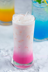 Pink hot milk in glass beautiful decorative marble pattern background.