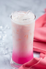 Pink hot milk in glass beautiful decorative marble pattern background.