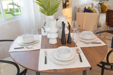 Dining room in a modern style with a round dining table with chairs.
