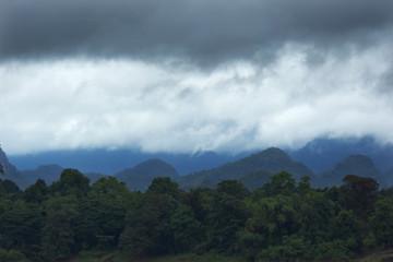 Raining cloud over the mountain and forest near border Thailand and Laos