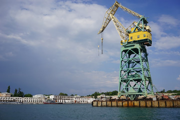 Fototapeta na wymiar Floating crane on the background of the seaport.