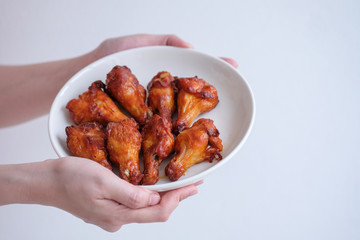 Hand holding new orleans chicken wings.