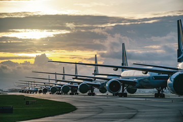 Aircraft are closely line up for long term parking at taxiway of airport due to COVID-19 