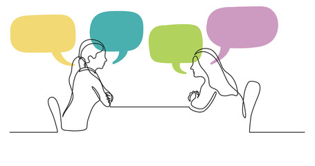 two young women sitting behind table talking with speech bubbles