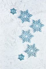 Merry Christmas and Happy New Year greeting card with blue snowflakes on shiny background with copy space. Flat lay. Top View.