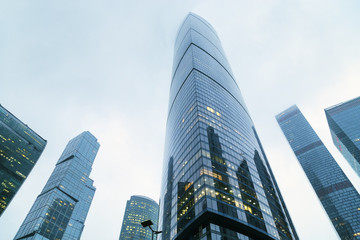 Obraz premium Modern corporate buildings against blue sky. High-rise buildings in Moscow city. Blue colored skyscrapers of business center.