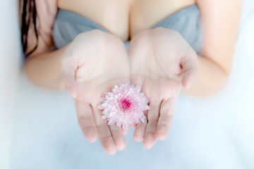 Milk bath in a tub with pink flowers