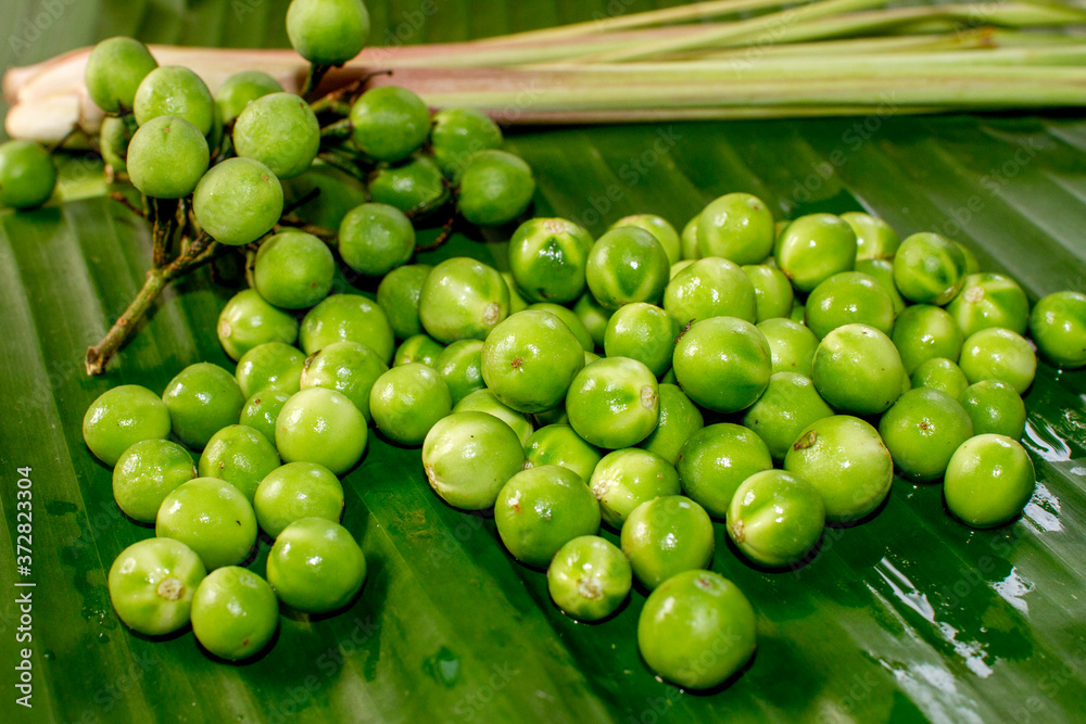 Wall mural eggplant on green banana leaf